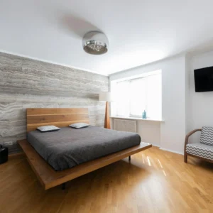 Dormitorio Minimalista con Pared de Piedra Natural y Madera