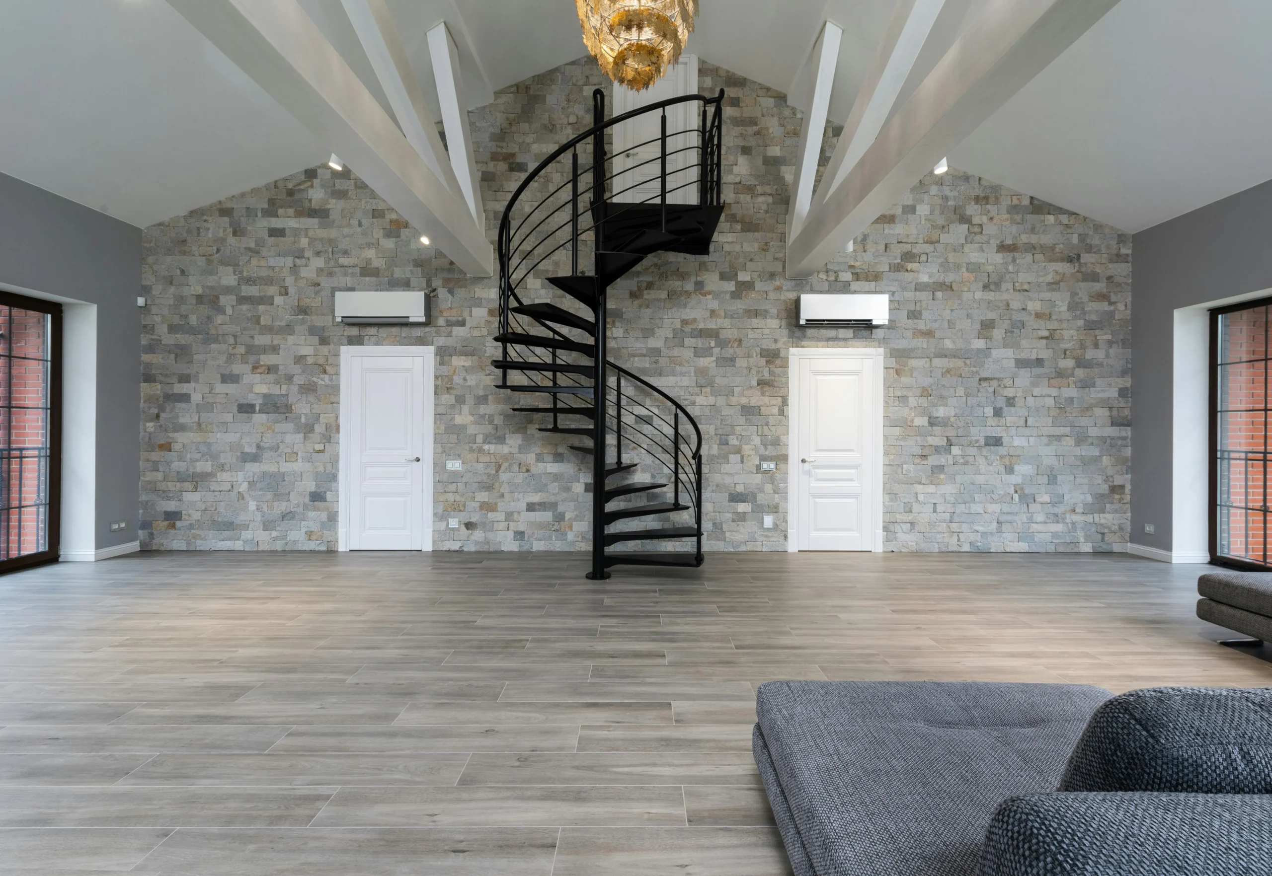 Loft Minimalista con Escalera Helicoidal y Pared de Piedra Natural
