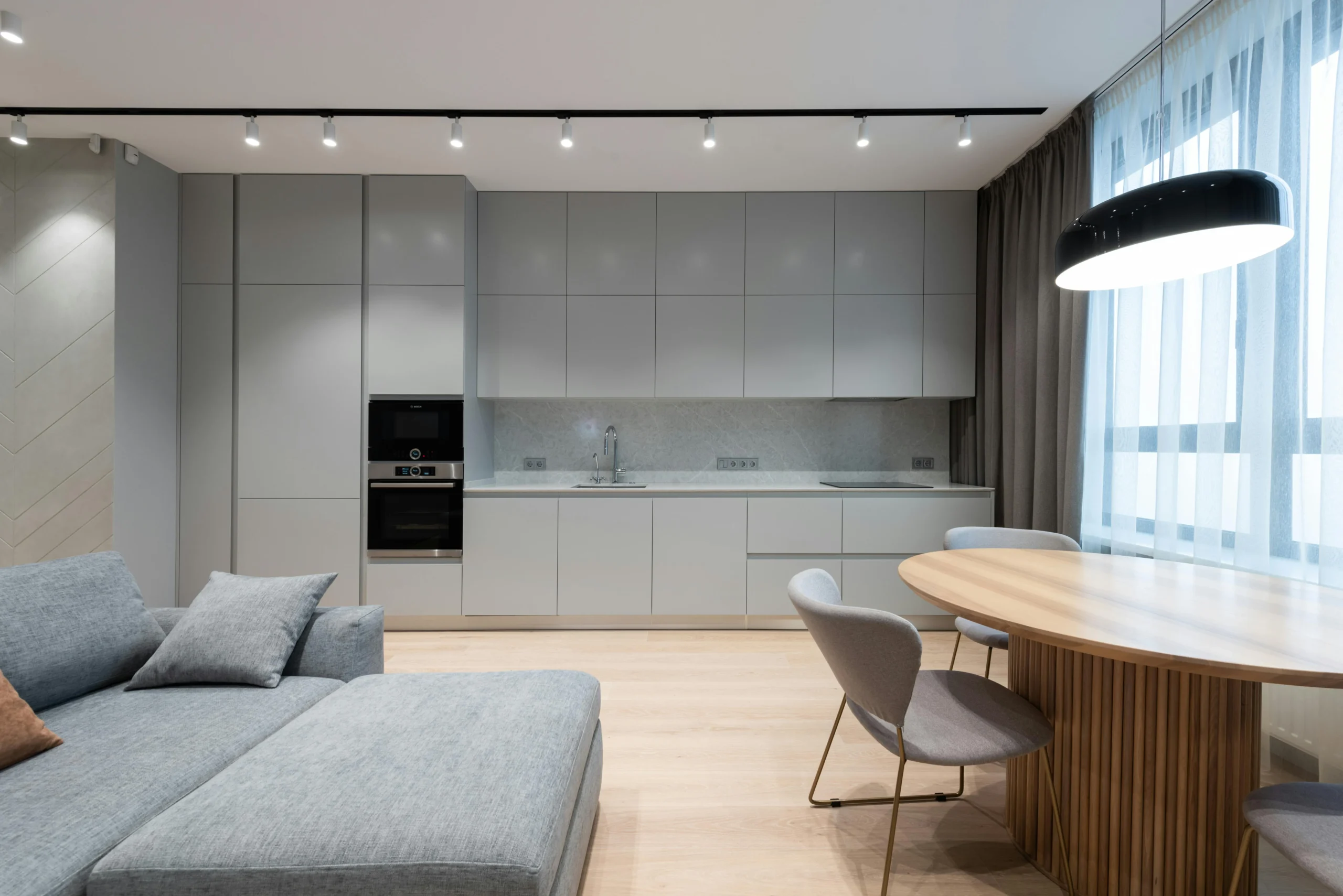 Cocina Minimalista en Gris Claro con Comedor Integrado